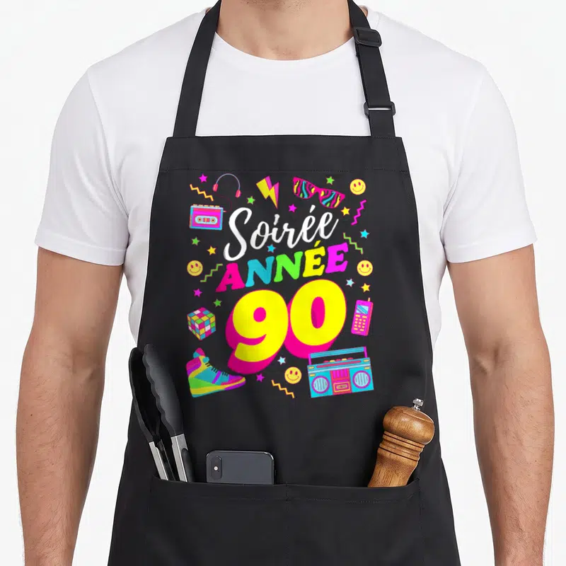 Tablier de cuisine noir avec illustration Soirée Année 90, boombox, cassette et sneakers colorées.
