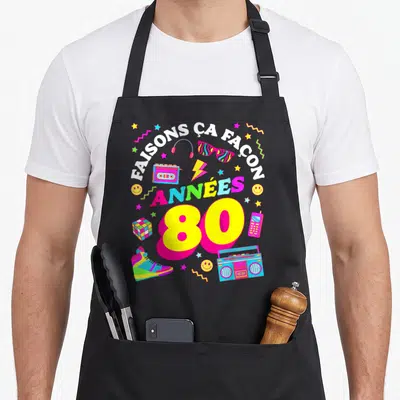 Tablier de cuisine noir avec illustration colorée Faisons ça façon Années 80 et objets rétro.