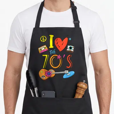 Tablier de cuisine noir avec illustration colorée I love the 70's, cassette et guitare.