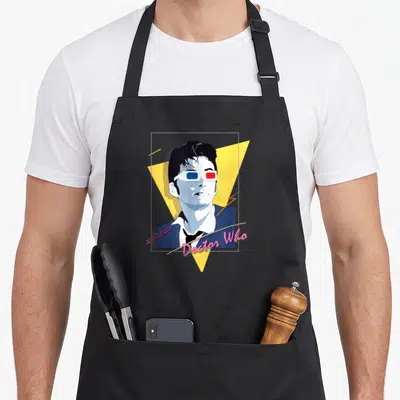 Tablier de cuisine noir avec portrait stylisé docteur en lunettes 3D et texte rose neon.