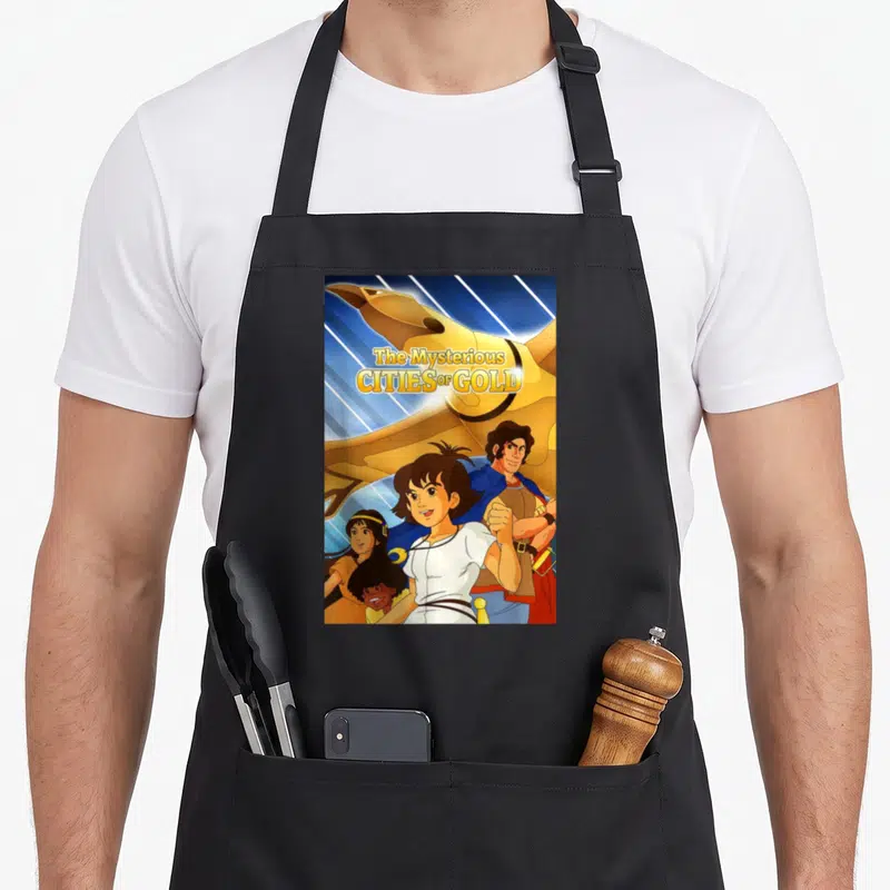 Tablier de cuisine noir avec illustration colorée du vaisseau doré et des personnages de l'animation rétro Les Mystérieuses Cités d'Or.