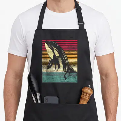 Tablier de cuisine noir avec illustration d'orque baleine rétro sur fond rayé rose orange et turquoise