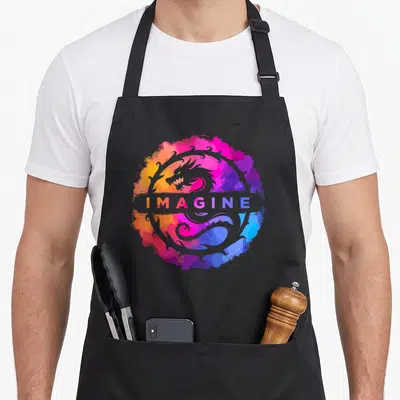 Tablier de cuisine noir avec un dragon rétro fantastique coloré et le mot Imaginez au centre.