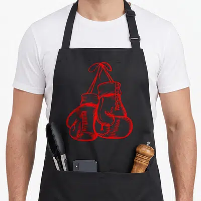 Tablier de cuisine noir avec illustration rouge de deux gants de boxe suspendus par leurs lacets en style dessin à la main.