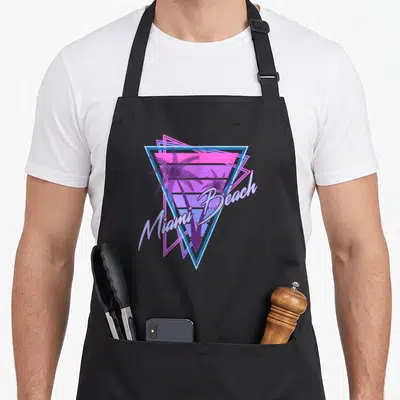 Tablier de cuisine noir avec motif triangle néon palmiers et texte Miami Beach en style rétro années 80