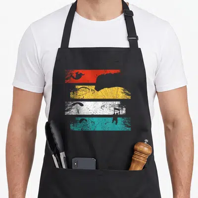 Tablier de cuisine noir avec parapentes et parachutes sur bandes colorées rouges jaunes blanches et turquoise style rétro
