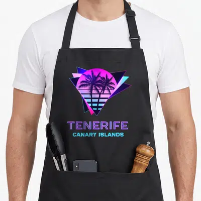Tablier de cuisine noir avec illustration néon de palmiers et texte Tenerife Canary Islands sur fond géométrique.
