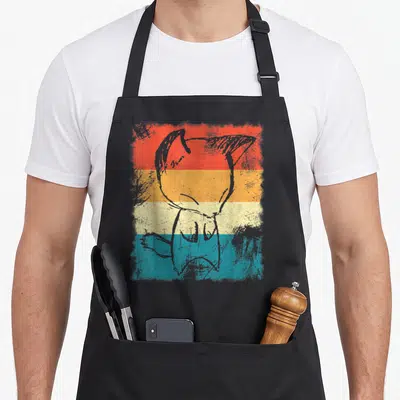 Tablier de cuisine noir avec illustration rétro d'un bébé renard amant sur bandes colorées orange jaune beige et bleu.