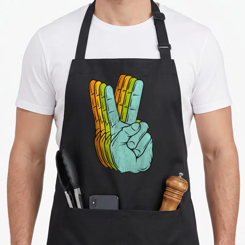 Tablier de cuisine noir avec illustration main peace sign multicolore style rétro