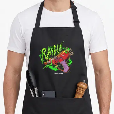 Tablier de cuisine noir avec illustration Raygun Zombie verte et rouge, texte Call of Duty en blanc en dessous.