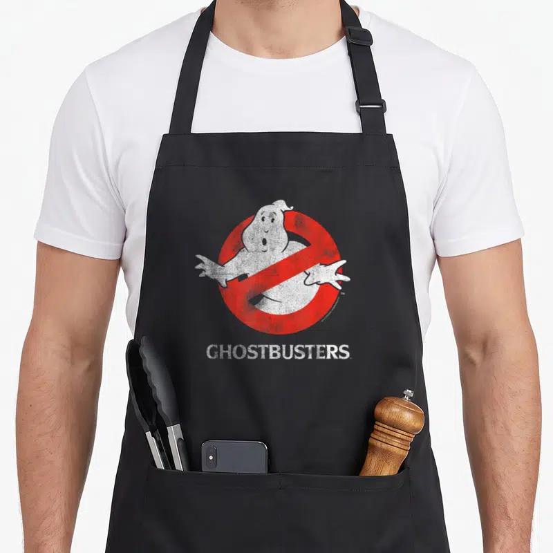 Tablier de cuisine noir avec l'emblème du fantôme barré rouge et blanc et le texte Ghostbusters en bas.