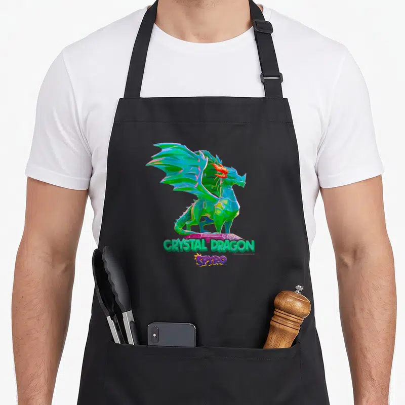 Tablier de cuisine noir avec un dragon vert cristal et l'inscription Crystal Dragon Spyro en lettres colorées.