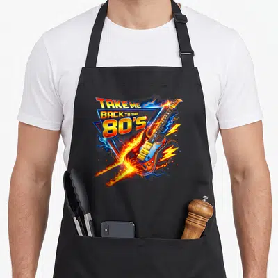Tablier de cuisine noir avec une guitare électrique enflammée et le texte Take Me Back to The 80's en lettres colorées.