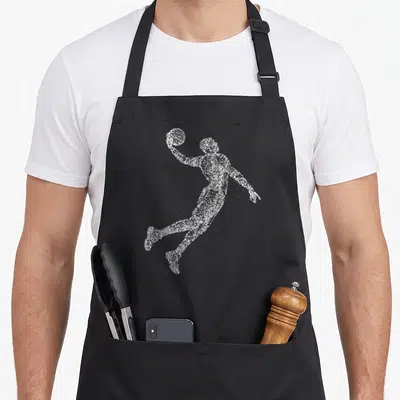 Tablier de cuisine noir avec une silhouette pointilliste blanche d'un basketteur rétro en action avec un ballon.
