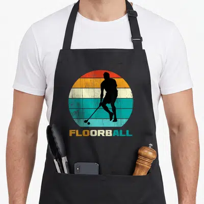 Tablier de cuisine noir avec silhouette joueur de floorball et texte coloré rétro