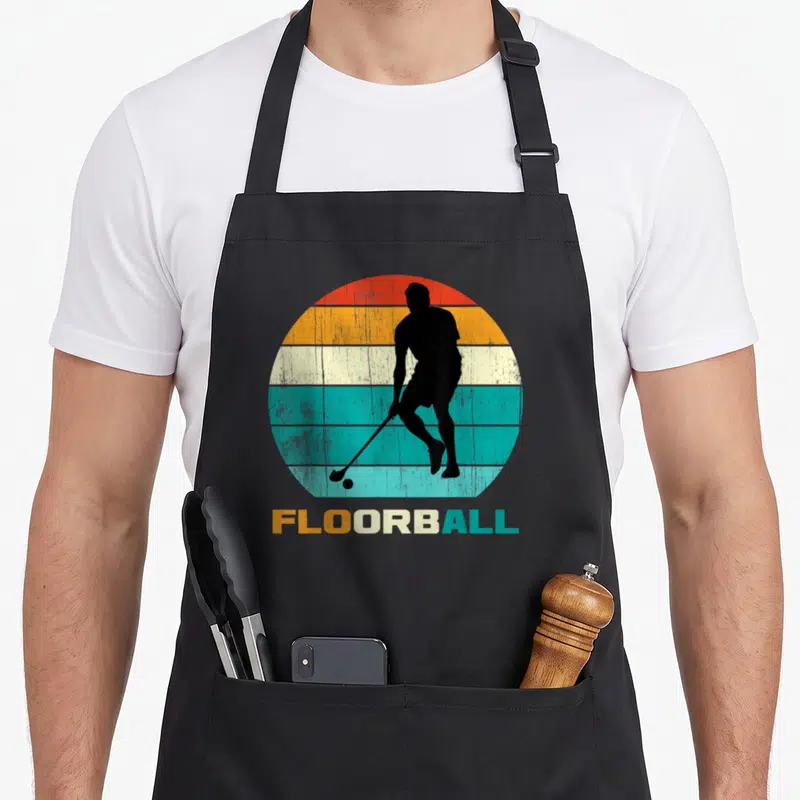 Tablier de cuisine noir avec silhouette joueur de floorball et texte coloré rétro