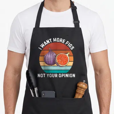 Tablier de cuisine noir avec une illustration de figues et le texte I Want More Figs Not Your Opinion en style rétro.