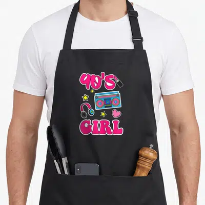 Tablier de cuisine noir avec illustration colorée 90's Girl incluant une radio-cassette et des étoiles jaunes.