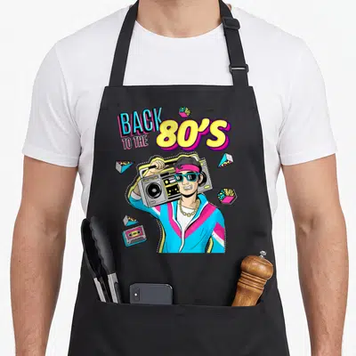 Tablier de cuisine noir avec illustration d'un homme portant une boombox et des lunettes de soleil dans un style graphique rétro coloré.