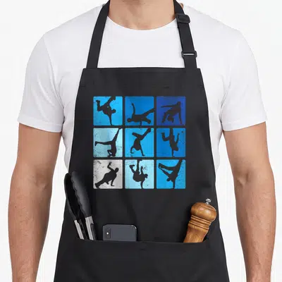 Tablier de cuisine noir avec neuf carrés bleus et blancs montrant des silhouettes de breakdanceurs en mouvement.