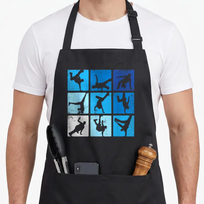 Tablier de cuisine noir avec neuf carrés bleus et blancs montrant des silhouettes de breakdanceurs en mouvement.