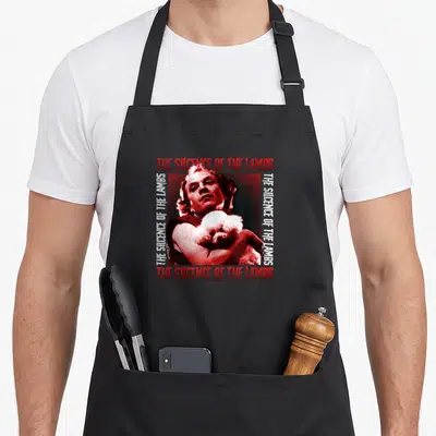 Tablier de cuisine noir avec illustration vintage rouge d'un homme tenant un chien poodle et le titre du film.