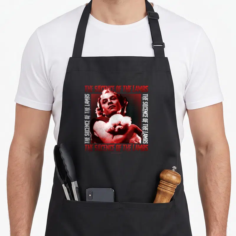Tablier de cuisine noir avec illustration vintage rouge d'un homme tenant un chien poodle et le titre du film.