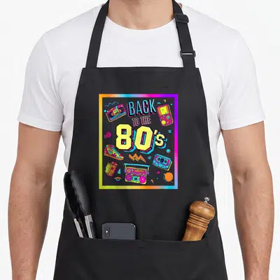 Tablier de cuisine noir avec illustration colorée Back to the 80's et objets rétro.