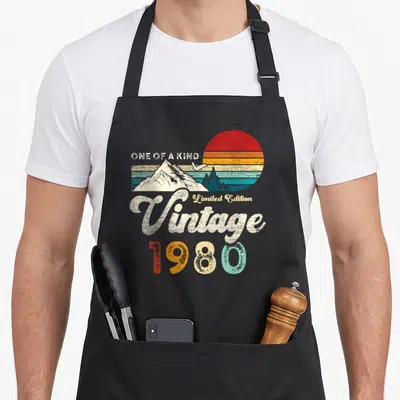 Tablier de cuisine noir avec illustration rétro 1980, montagnes, aigle et texte One of a Kind.