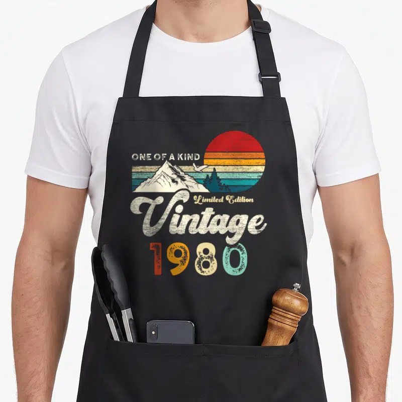 Tablier de cuisine noir avec illustration rétro 1980, montagnes, aigle et texte One of a Kind.