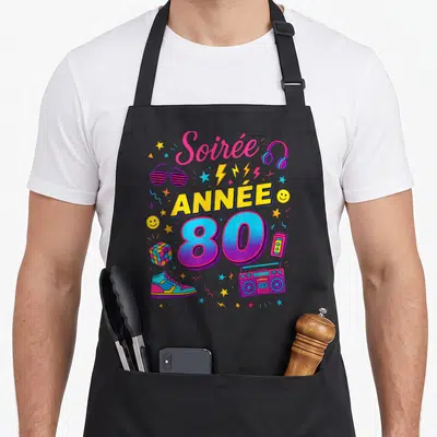 Tablier de cuisine noir avec illustration Soirée Année 80 colorée incluant boombox et lunettes rayées.