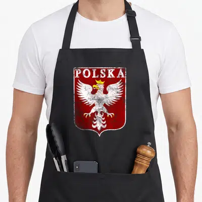 Tablier de cuisine noir avec un aigle blanc couronné et le mot POLSKA sur fond rouge texturé.