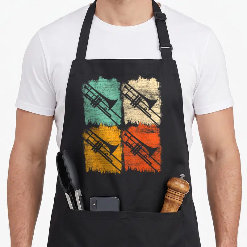 Tablier de cuisine noir avec quatre trombones rétro sur fonds colorés texturés turquoise beige orange et rouge