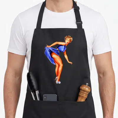 Tablier de cuisine noir avec illustration d'une Pin-up Girl en robe bleue et talons blancs style années 1940.