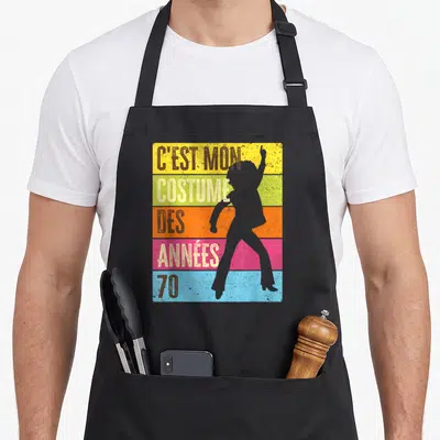 Tablier de cuisine noir avec silhouette disco et texte C'est mon costume des années 70 sur fond multicolore