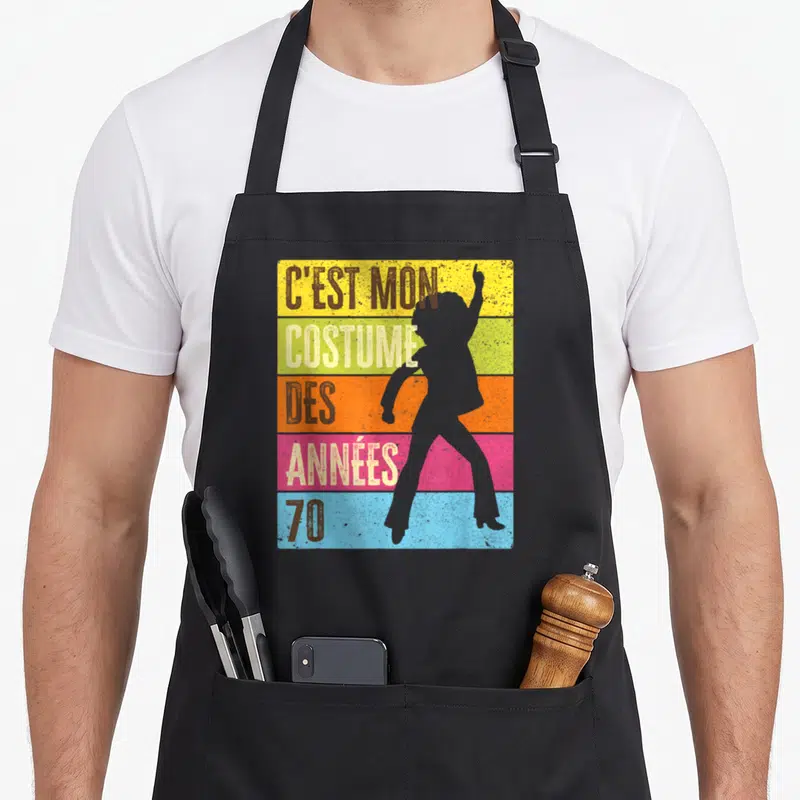 Tablier de cuisine noir avec silhouette disco et texte C'est mon costume des années 70 sur fond multicolore