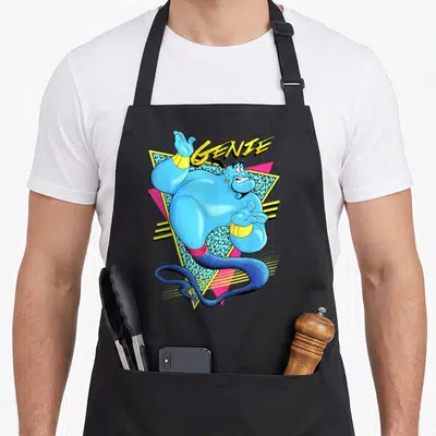 Tablier de cuisine noir avec illustration rétro du Génie bleu et le texte GENIE en jaune sur fond géométrique.