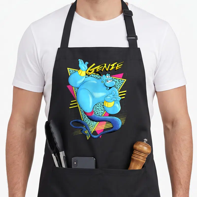 Tablier de cuisine noir avec illustration rétro du Génie bleu et le texte GENIE en jaune sur fond géométrique.
