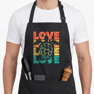 Tablier de cuisine noir avec illustration tortue et texte Love Love Love en dégradé orange jaune vert turquoise