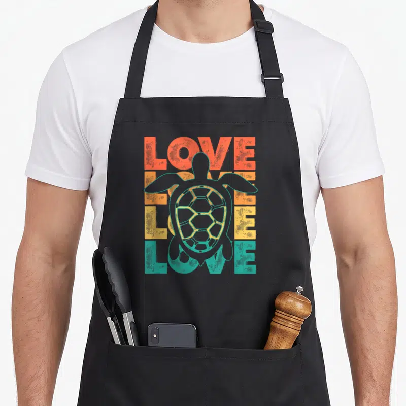 Tablier de cuisine noir avec illustration tortue et texte Love Love Love en dégradé orange jaune vert turquoise