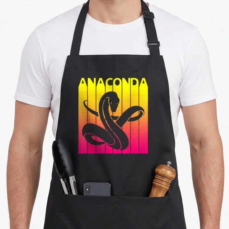 Tablier de cuisine noir avec illustration d'anaconda sur fond dégradé jaune et rose à lignes verticales