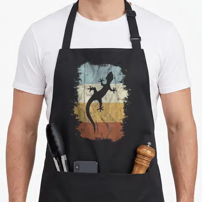 Tablier de cuisine noir avec silhouette gécko sur bandes bleue blanche jaune et orange texturées