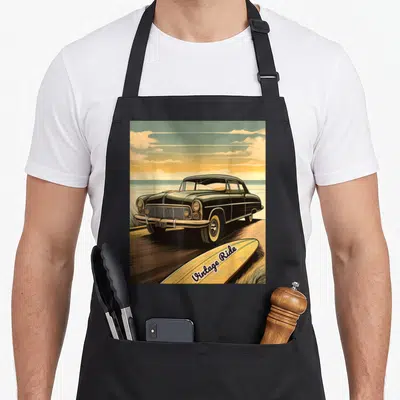 Tablier de cuisine noir avec illustration voiture américaine, surf jaune et texte Vintage Ride.