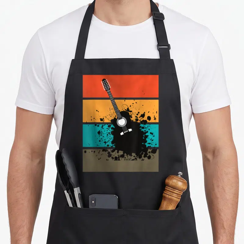 Tablier de cuisine noir avec illustration d'une guitare noire sur bandes colorées orange turquoise et ocre style rétro.