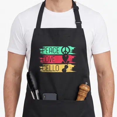 Tablier de cuisine noir avec inscription PEACE LOVE CELLO et symboles rétro sur bandes mint, rose et jaune