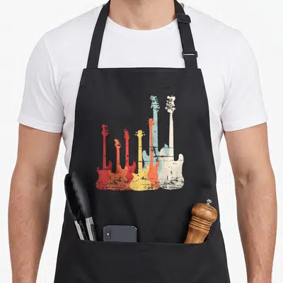Tablier de cuisine noir avec sept silhouettes de guitares électriques multicolores et texture vieillie.
