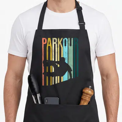 Tablier de cuisine noir avec inscription PARKOUR multicolore et silhouette grise d'un athlète en mouvement dynamique.