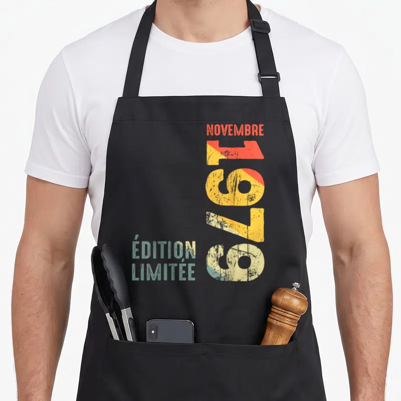 Tablier de cuisine noir avec typographie verticale colorée et texte « Édition limitée » en bas à gauche.