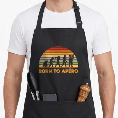 Tablier de cuisine noir avec illustration rétro évolution homme bière et texte Born to Apéro en orange.