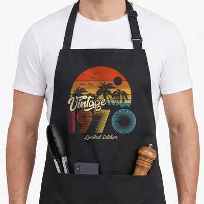 Tablier de cuisine noir avec illustration rétro 1970 Limited Edition soleil couchant et palmiers
